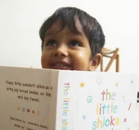 Aniket from Chennai smiling looking at The Little Shloka Book