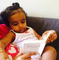Avani from Mumbai looking attentively into The Little Shloka Book